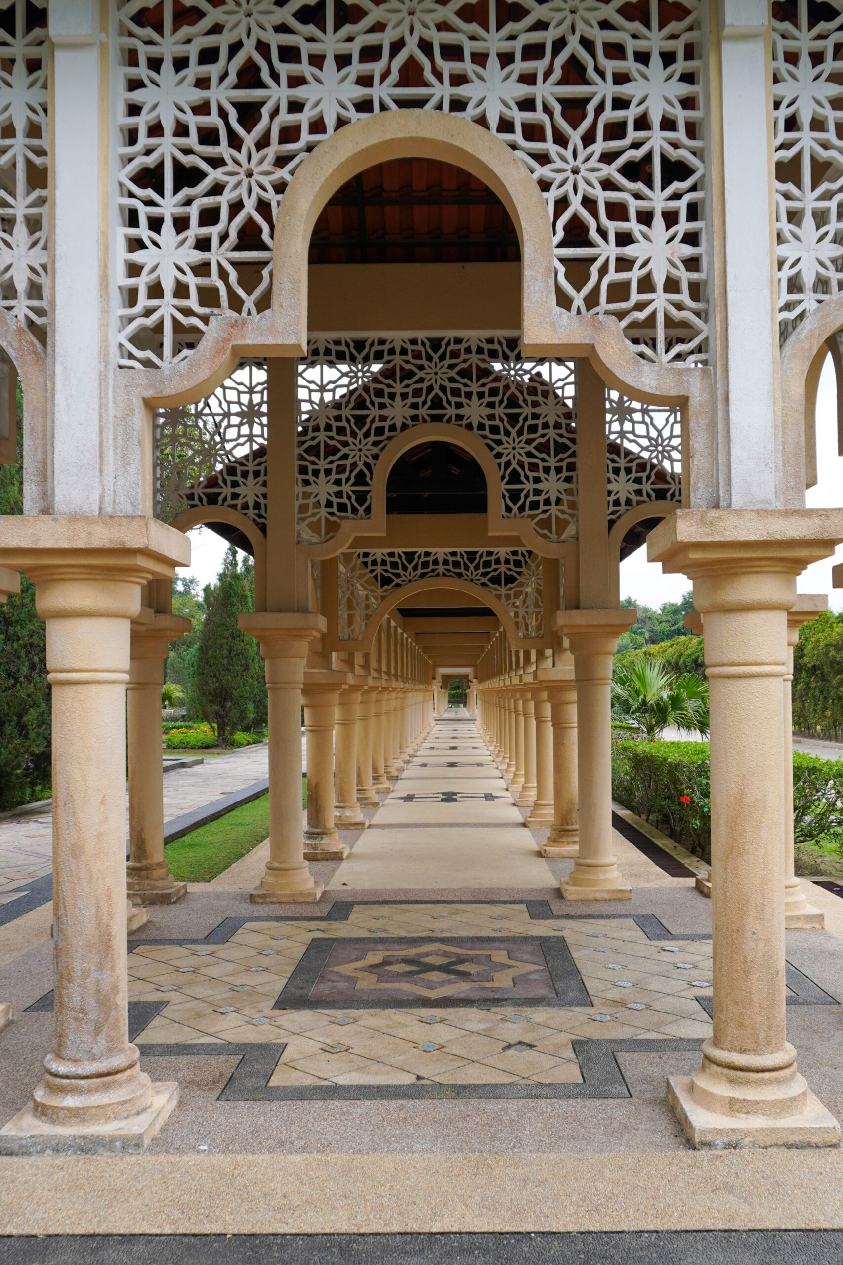 Ornate pedestrian walkway with symmetrical columns in Kota Iskandar, Malaysia.